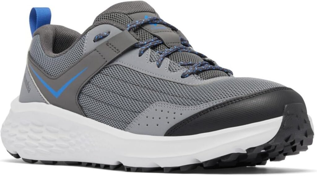 A grey Columbia trail running shoe with a white speckled midsole and a durable black outsole, featuring blue accents and blue laces.