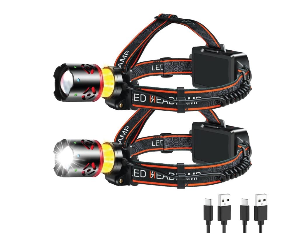 A set of two black and orange portable rechargeable headlamps, one with its light illuminated, and two USB charging cables shown below.