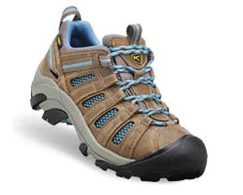A single women's hiking shoe in tan and brown with light blue mesh accents and blue laces, featuring a black toe guard and a rugged outsole.
