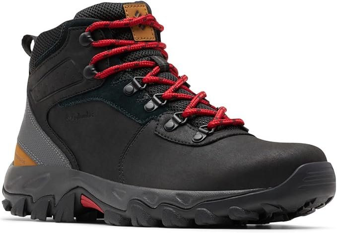 A black Columbia Newton Ridge Plus II hiking boot with bright red laces, a grey stripe on the side, and a textured black and red outsole, designed for durability and outdoor performance.