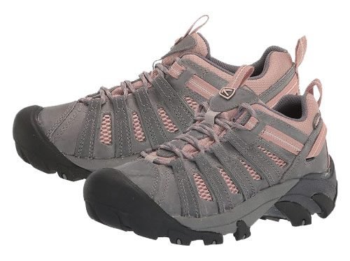 A pair of women's hiking shoes in grey with pink mesh accents, featuring a durable toe cap and rugged outsole for outdoor activities.