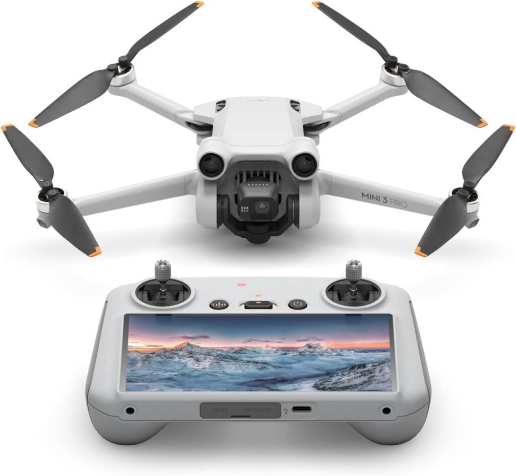 A white DJI Mini 3 Pro drone with its four propellers and an integrated camera facing forward, positioned above its gray remote controller. The remote controller features a built-in screen displaying a panoramic winter mountain landscape at sunset, with joysticks and control buttons visible. This setup represents a leading option for the Best Drone Camera.