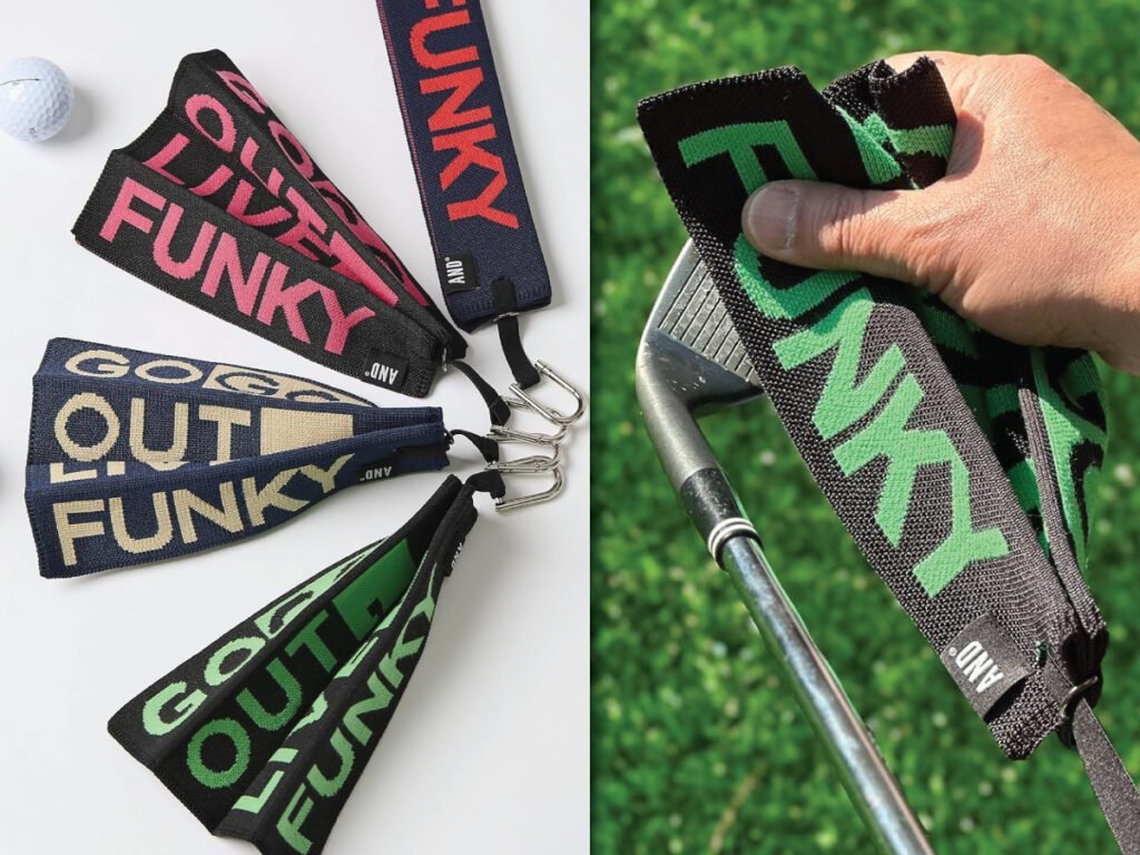 Three colorful golf towels with the word FUNKY on them, and a hand holding a green one to wipe a golf club.